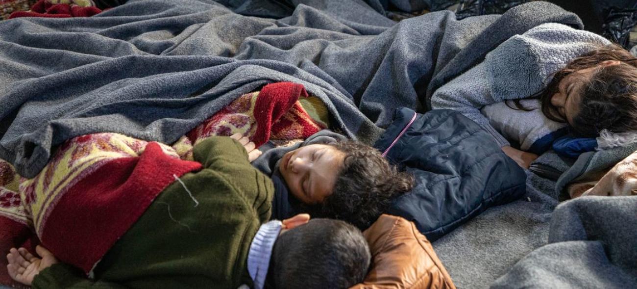 Children sleeping under blankest at a mosque in the Al-Midan district of Aleppo, Syria