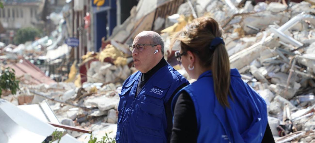IOM Director General Antonio Vitorino stands among the destruction in Antakya city caused by recent earthquakes