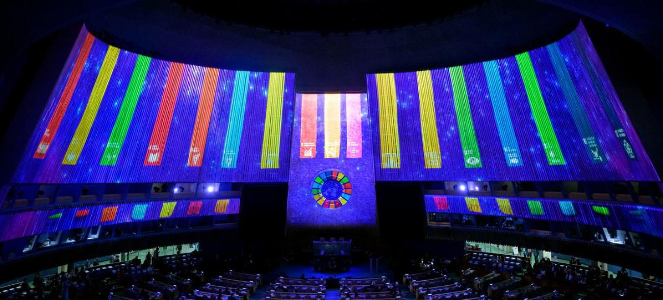 SDG logos are projected in the UN General Assembly Hall in 2022.