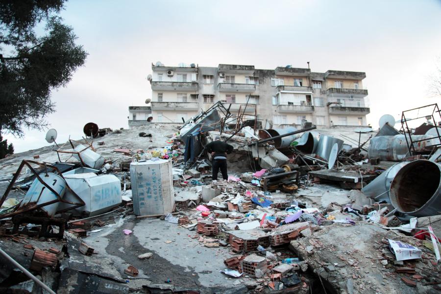 Rubbles damaged buildings a man standing on the rubbles