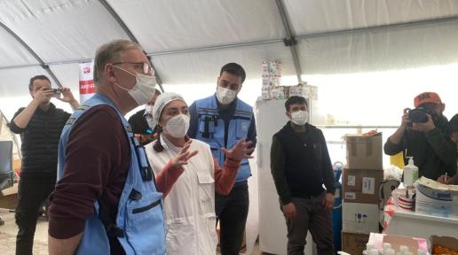 UN RC speaking to health personnel inside a health tent in the earthquake area