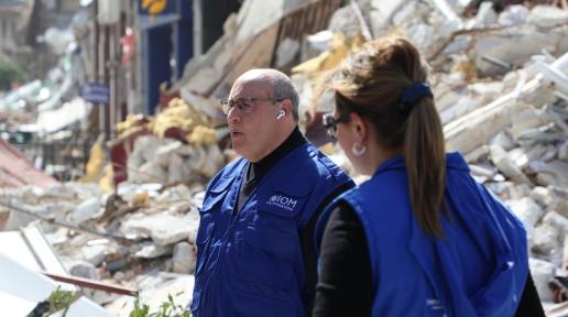 IOM Director General Antonio Vitorino stands among the destruction in Antakya city caused by recent earthquakes