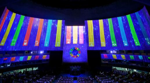 SDG logos are projected in the UN General Assembly Hall in 2022.